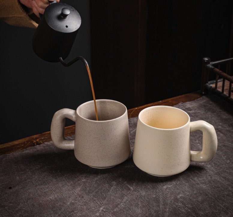Ceramic mugs featuring detailed patterns from low-temperature firing
