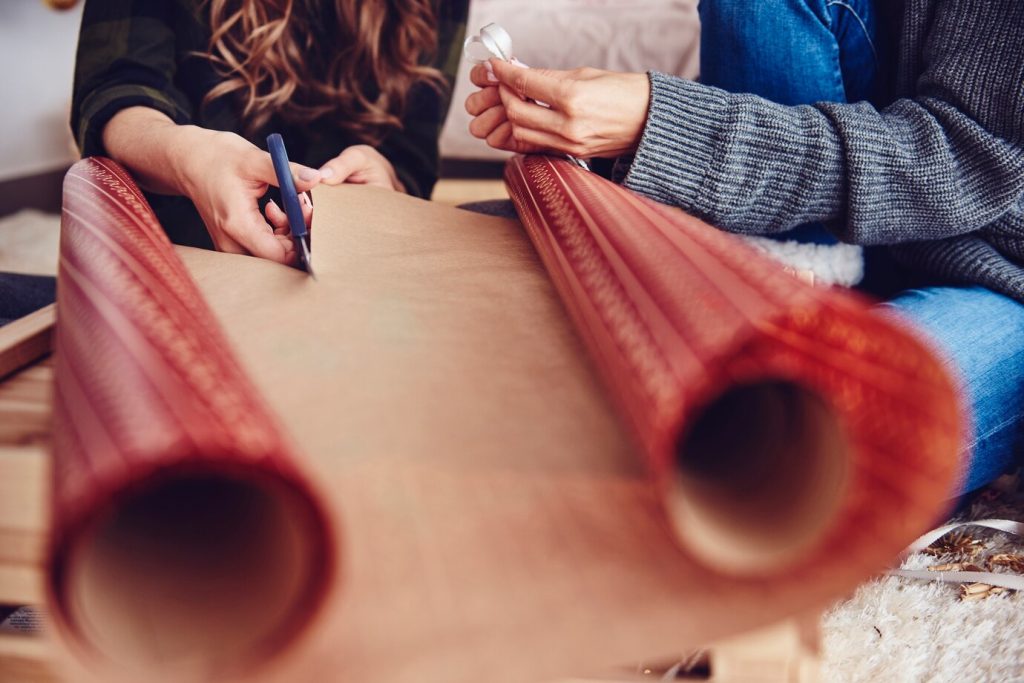 hands cutting material during an eco-friendly manufacturing step