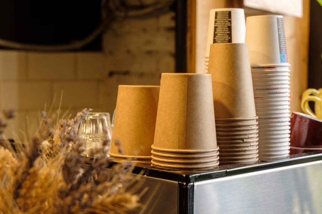 paper coffee cups displayed at a local coffee shop