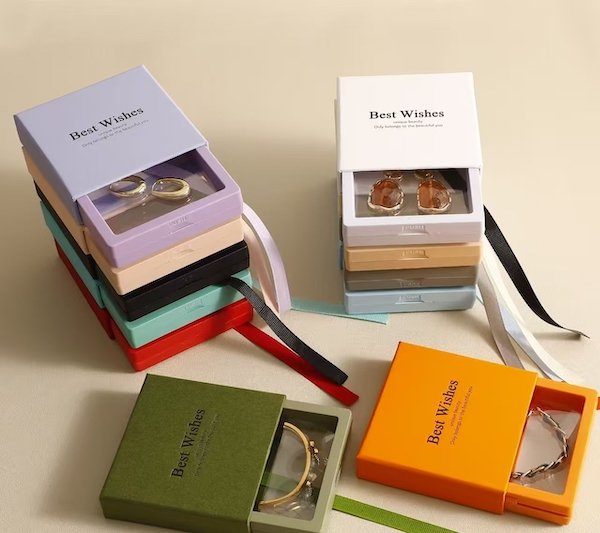 Colorful gift boxes with "Best Wishes," displaying jewelry like earrings and bracelets