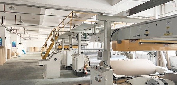 Industrial paper production equipment in a factory setting