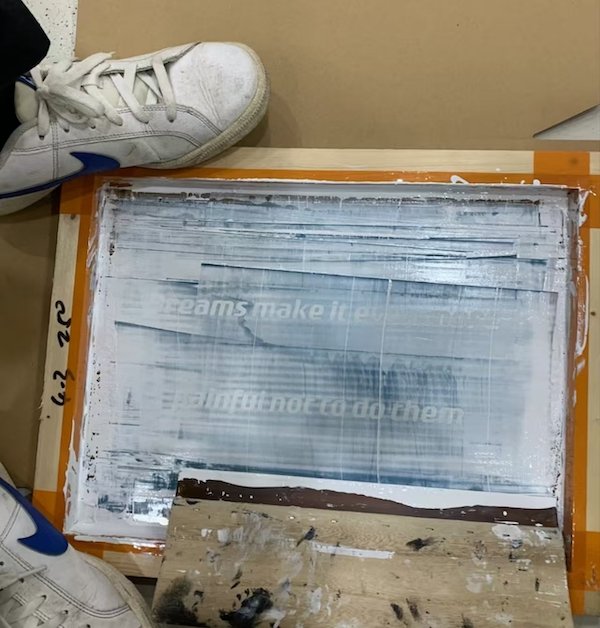Screen printing process with text partially visible on the screen