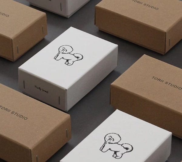 Minimalist packaging with white and brown boxes featuring a cute dog illustration