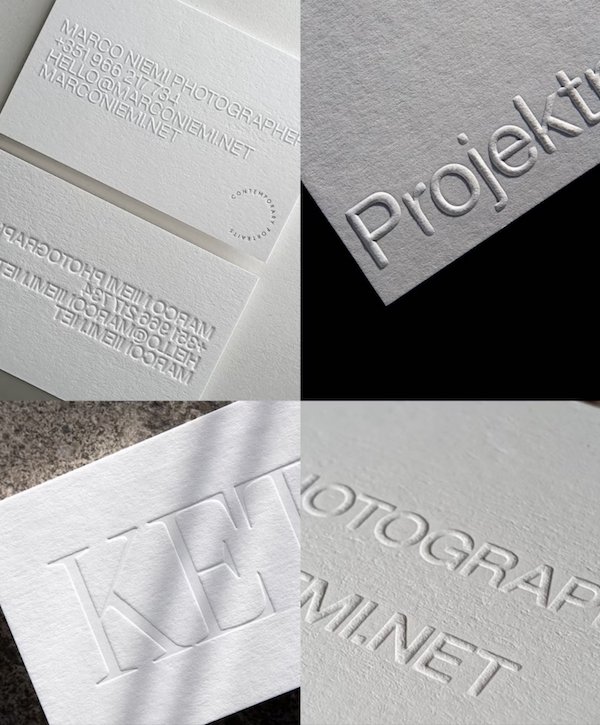 Minimalist white embossed business cards with clean typography and professional design