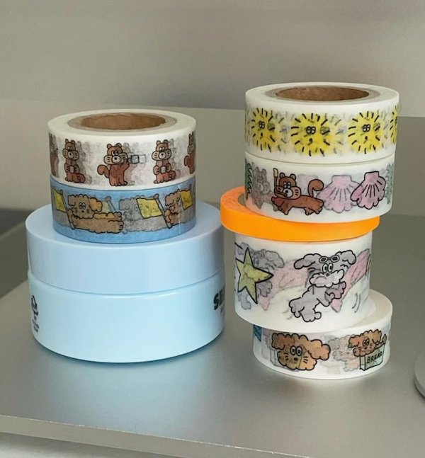 Colorful rolls of decorative tape featuring playful cartoon animal designs