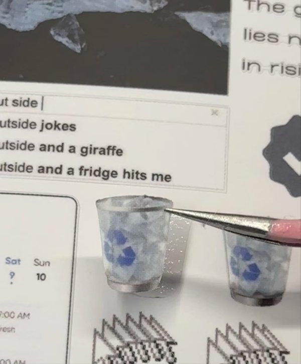 Close-up of tiny recycling bin stickers with humorous text in the background