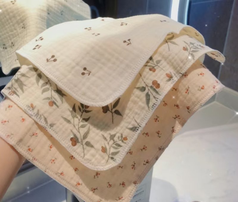 Soft muslin towels with delicate floral patterns in a bathroom setting