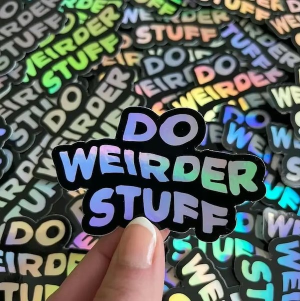 Holographic sticker with the text "DO WEIRDER STUFF"