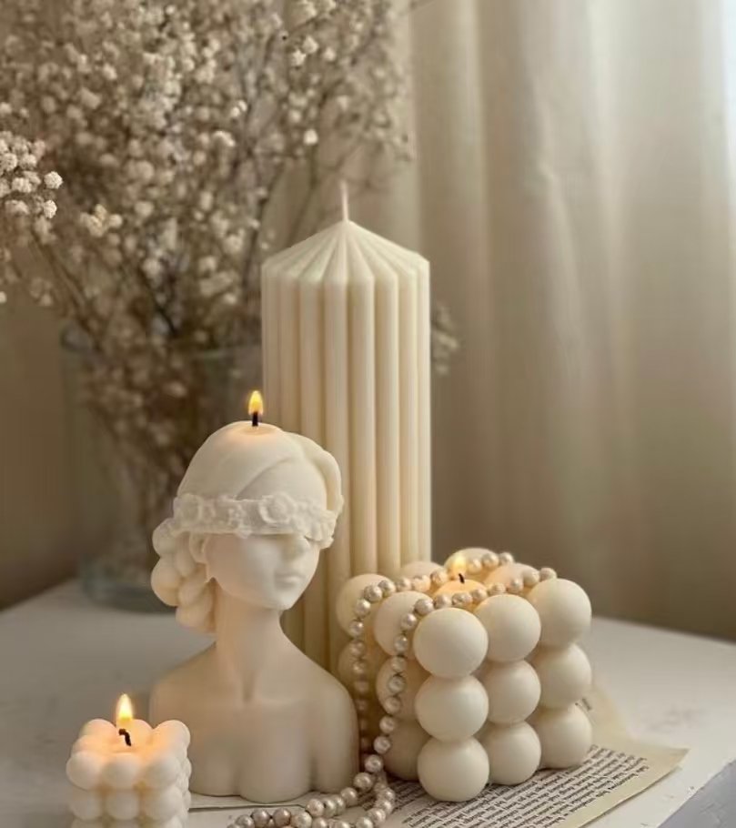 Custom-shaped aromatherapy candle burning evenly on a table
