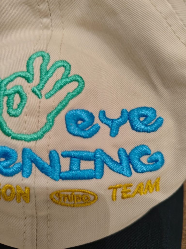 Logo being embroidered onto the front panel of a cap