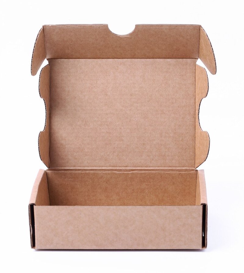 Open kraft cardboard box with die-cut design on a white background
