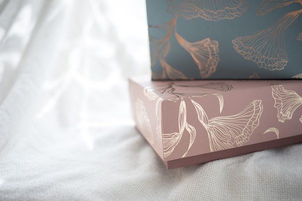 Decorative gift boxes with floral patterns, soft pastel pink and blue tones
