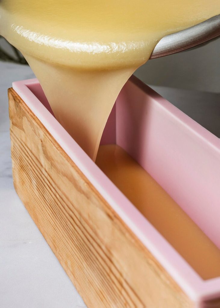 mass-produced paraffin wax candles arranged together