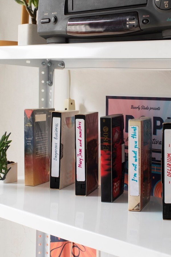 Shelf with vintage VHS tapes and a retro VCR on top