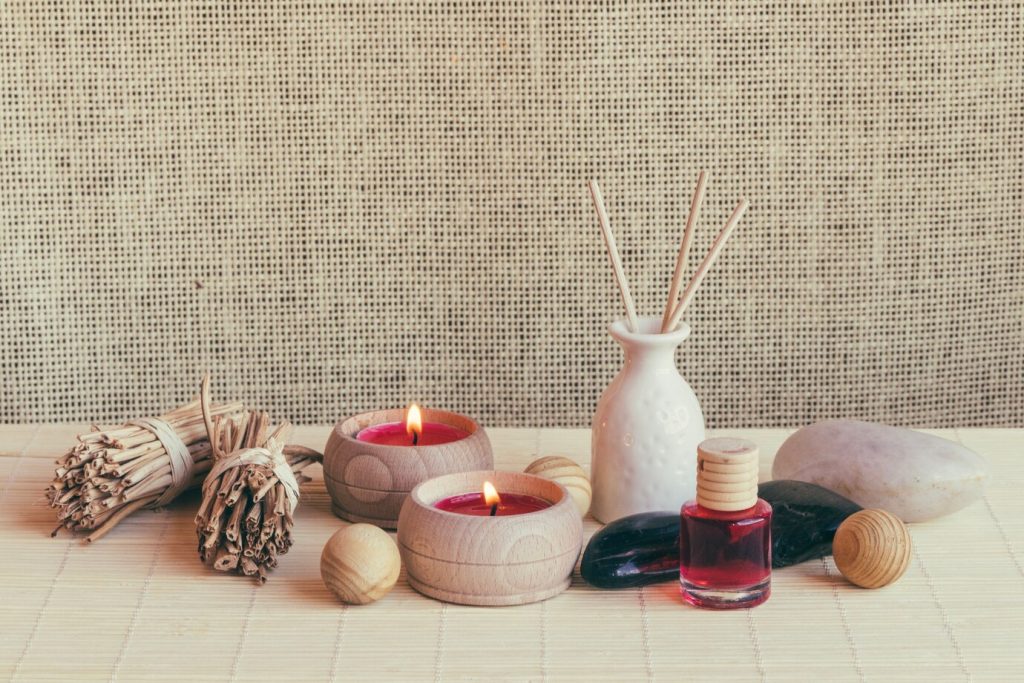 candles and essential oil bottles arranged in a spa setting