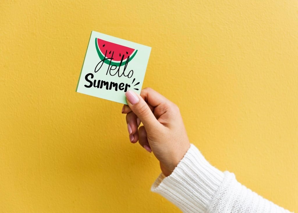 Sticker mockup with a summer-themed note against a yellow wall