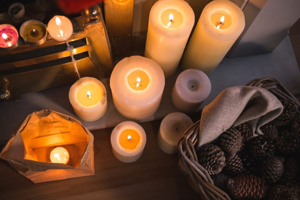 Candles arranged with pine cones in a seasonal display