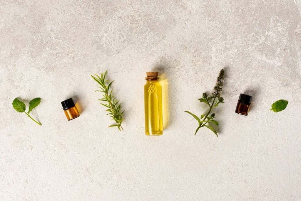 sandalwood essential oil and candle in a calming spa arrangement
