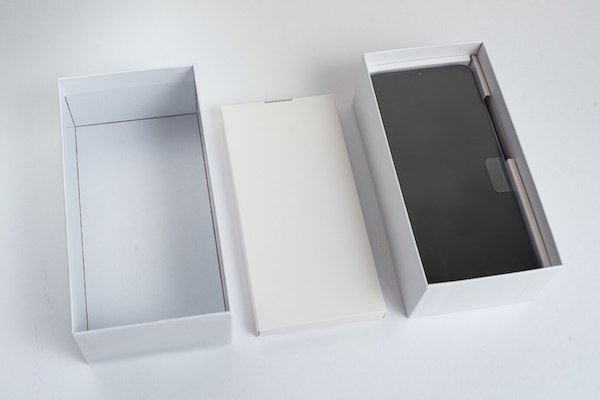Smartphone unboxing with white packaging, phone displayed inside