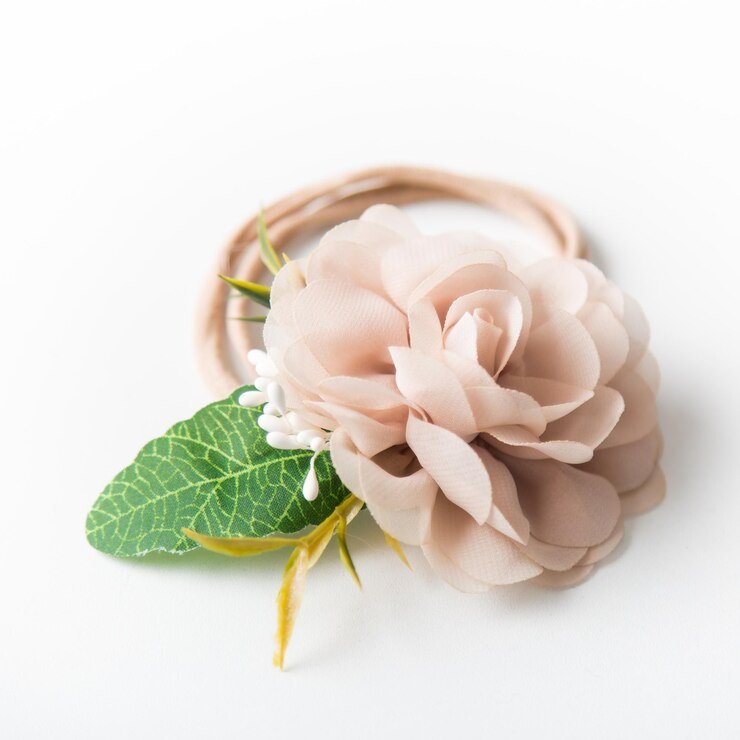 Beige fabric flower with green leaves