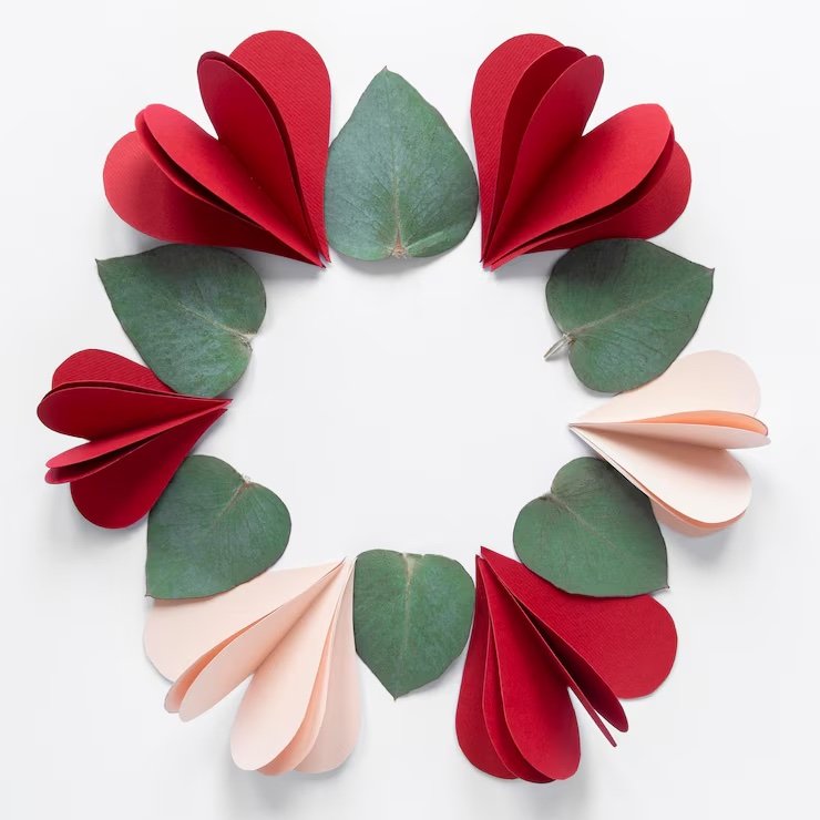 Paper heart and leaf shapes arranged in a circular pattern