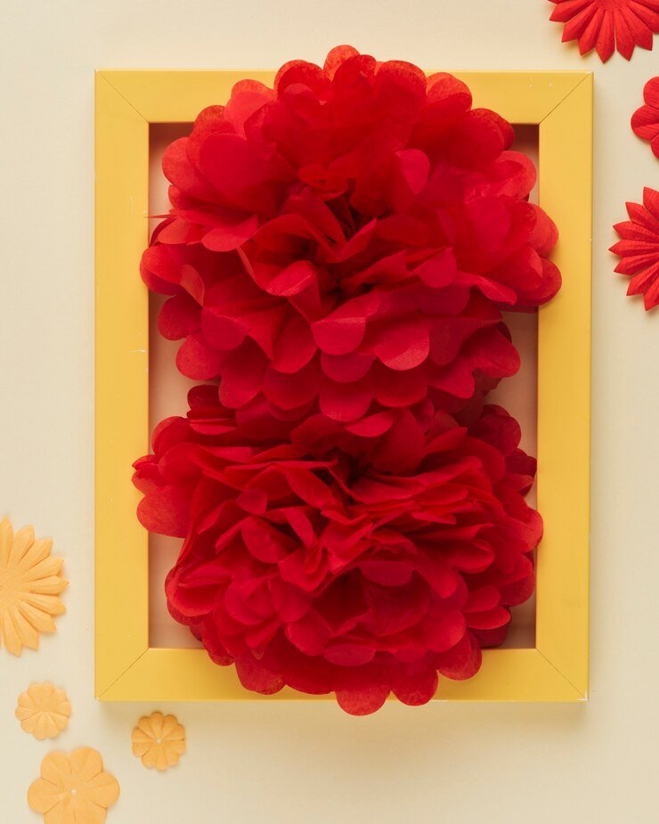 Colorful paper flowers in a frame, red and yellow design