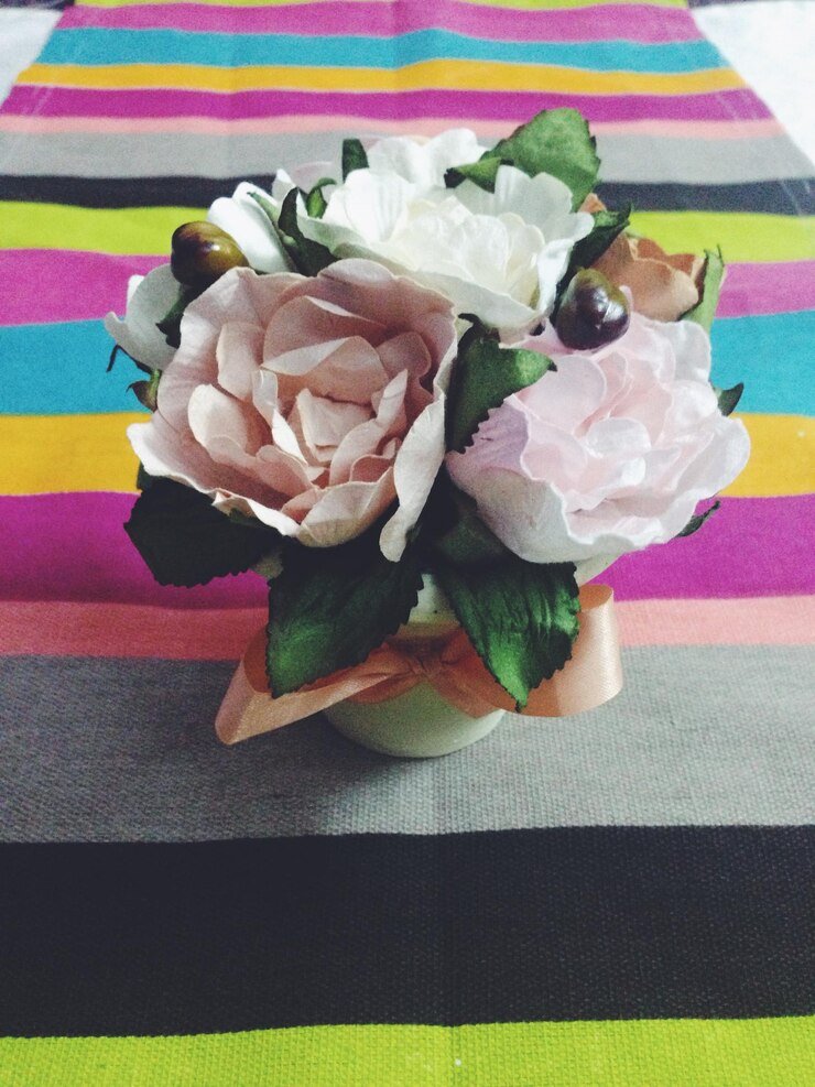 Soft pastel artificial roses in a small vase