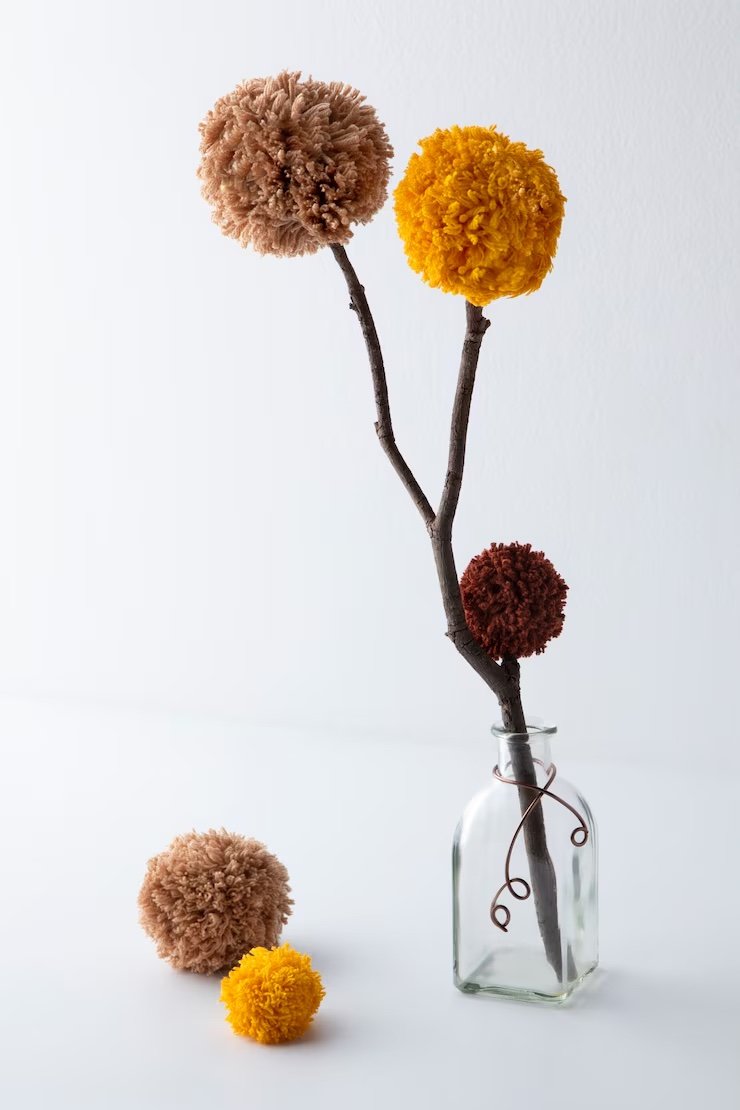 Pom-pom flowers in a glass bottle