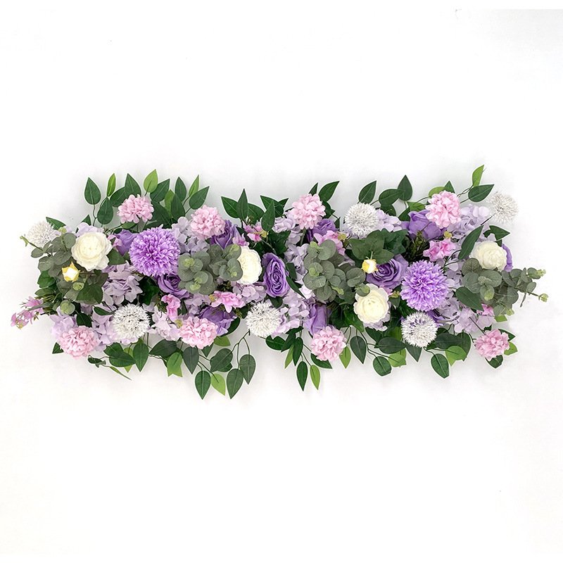 Purple, pink, and white paper flowers with greenery arranged flat