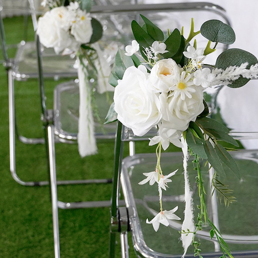 White floral decoration on transparent chairs for event