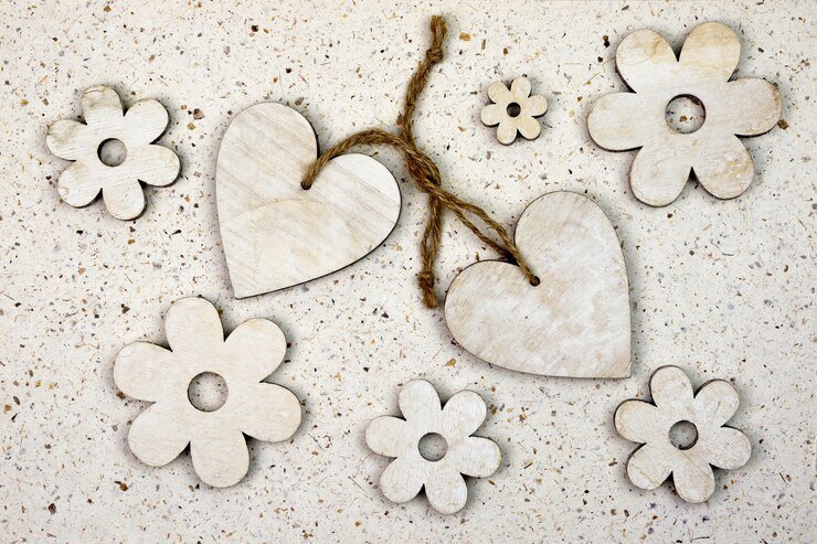 wooden flowers and hearts on light background
